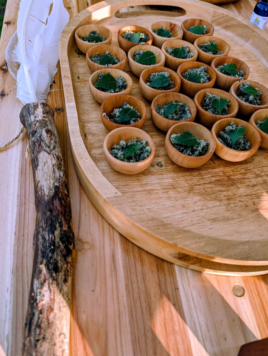a wooden tray with small bowls of salt body scrub