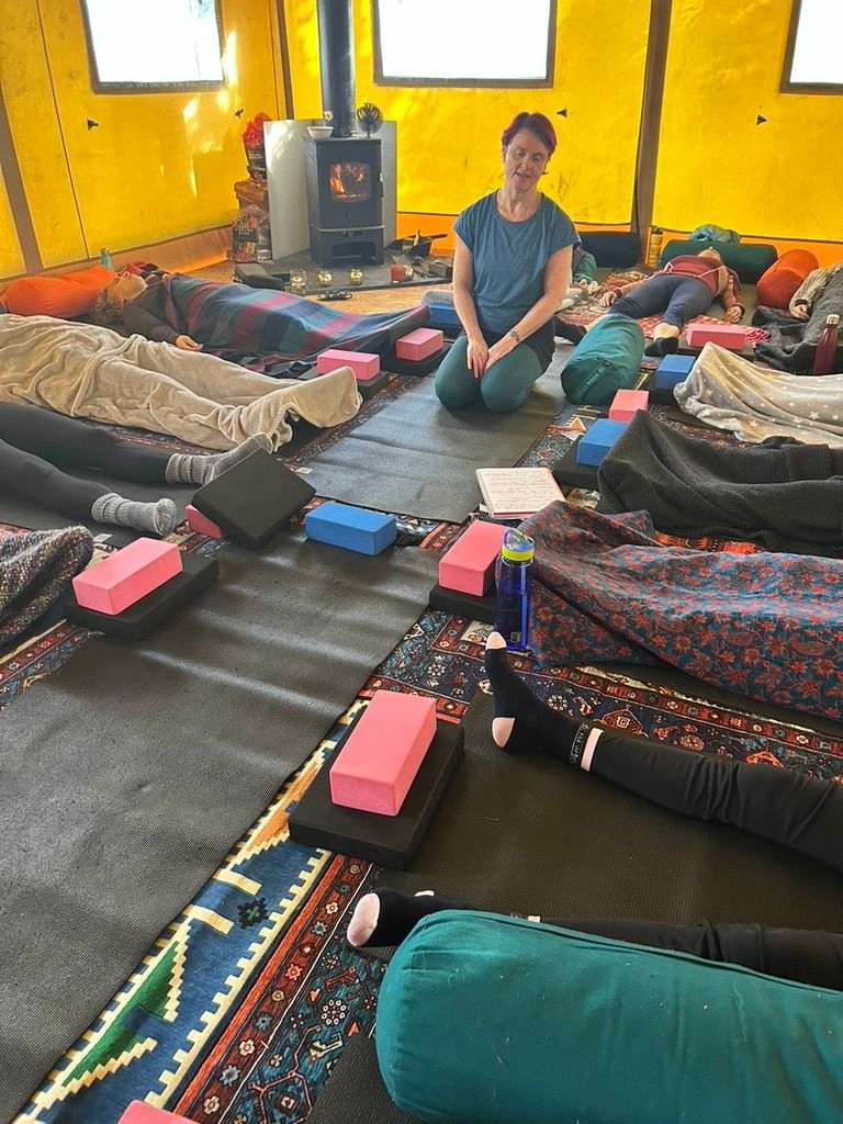People lying down during a yin yoga session 