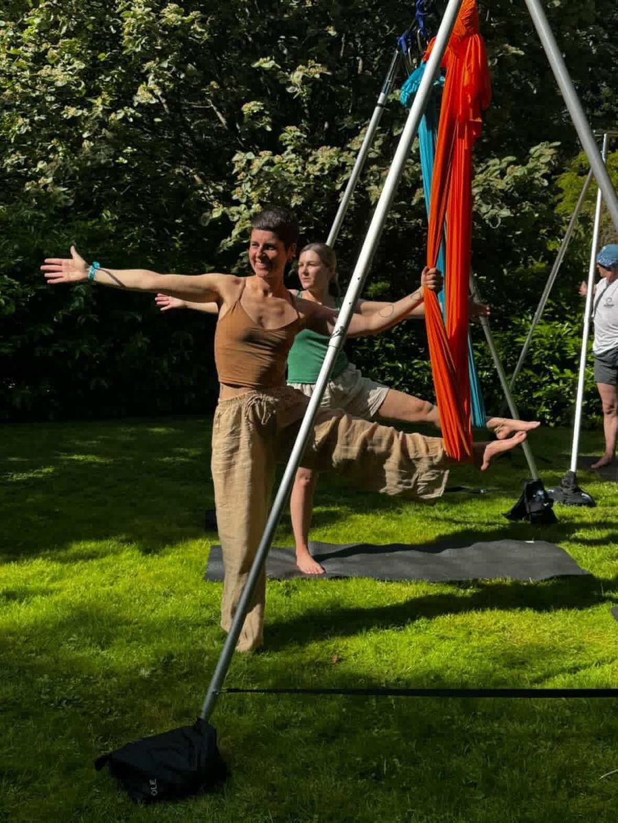 An outdoor aerial yoga class on the lawn at Court Farm Lakes