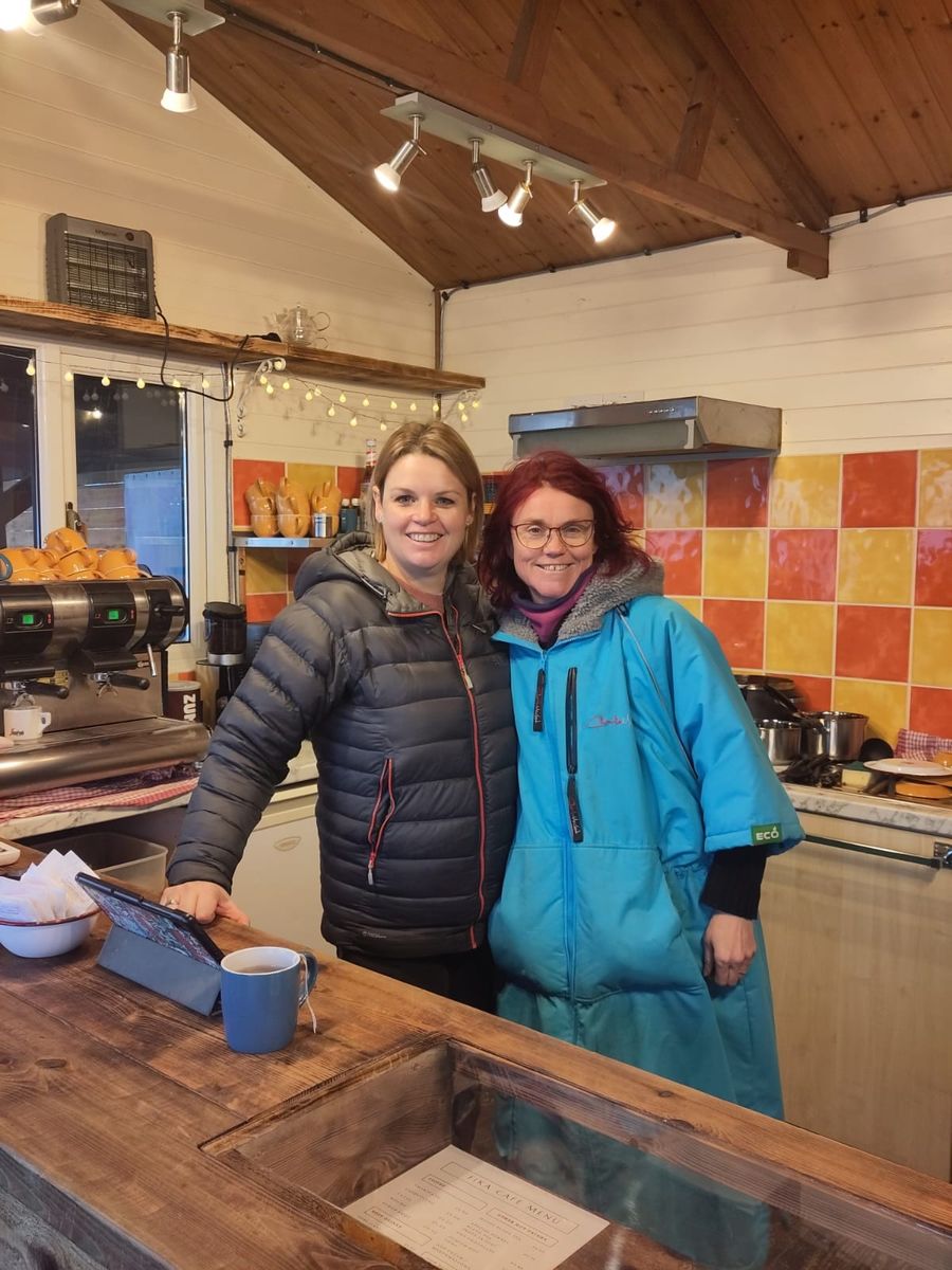 Two of the café team behind the counter by the coffee machine, Court Farm Lakes