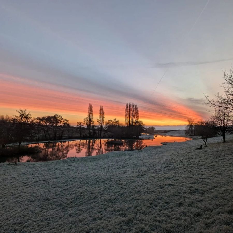 Frost on the bank and a red sunrise over the lake, Court Farm Lakes