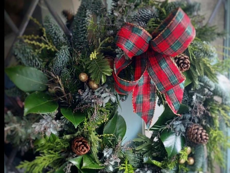 A Christmas wreath with a tartan bow, wreath making workshop at Court Farm Lakes