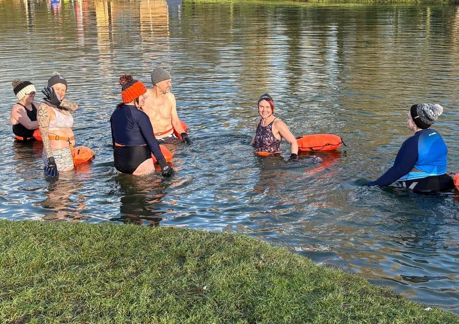 A cold water induction group in the lake in winter hats, Court Farm Lakes