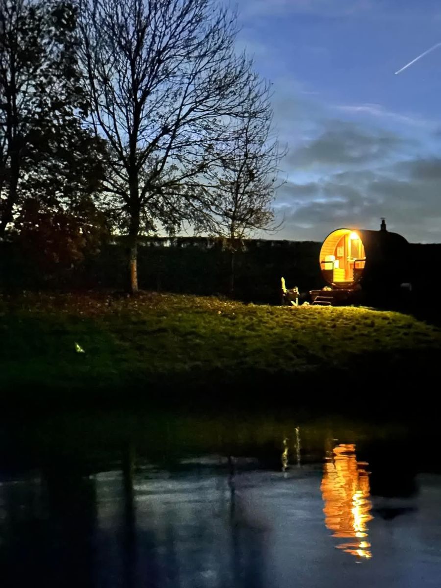 The sauna glowing on the bank at dusk, Court Farm Lakes