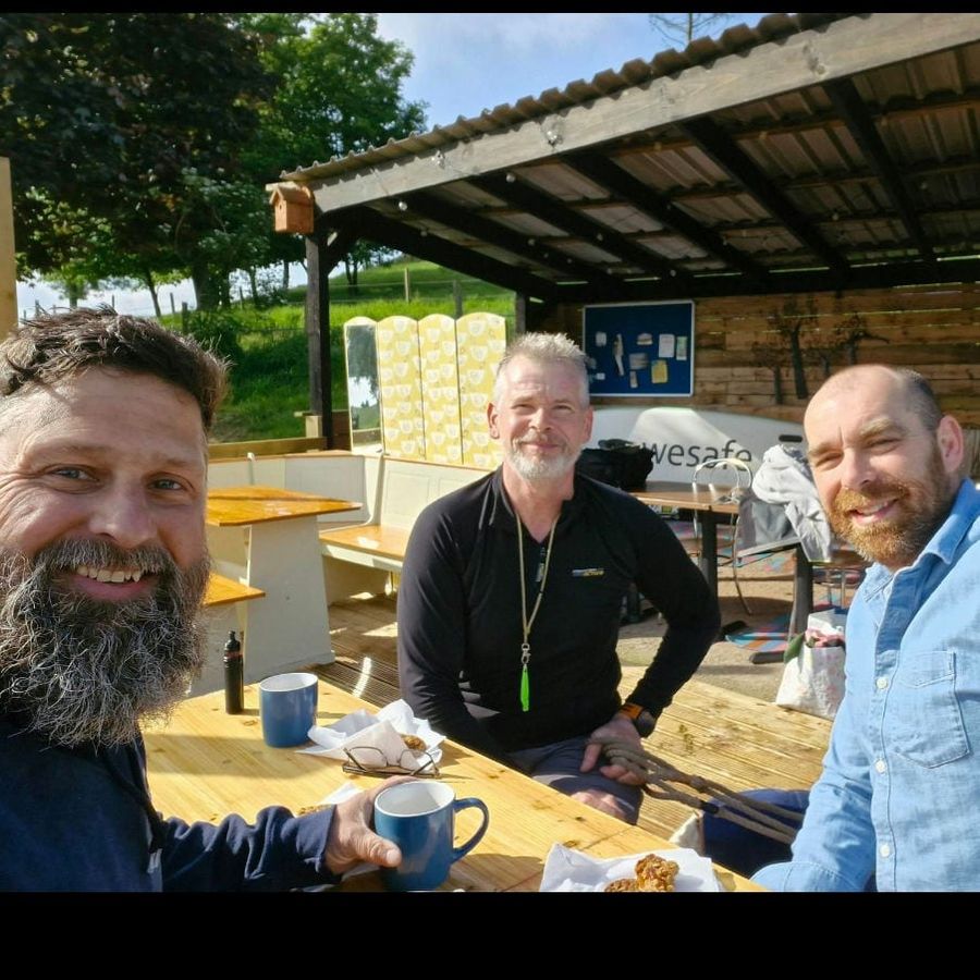 Barry Welch and friends with mugs outside the café, Court Farm Lakes