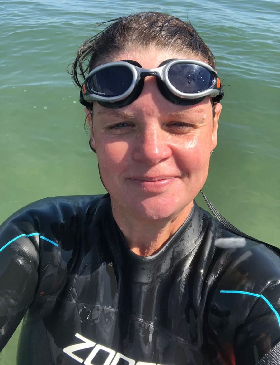 Jo York in her wetsuit and goggles in the lake, Court Farm Lakes
