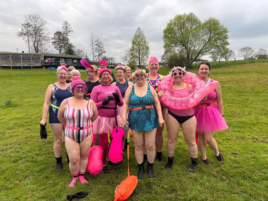 A women's swim group in pink fancy dress on the bank, Court Farm Lakes